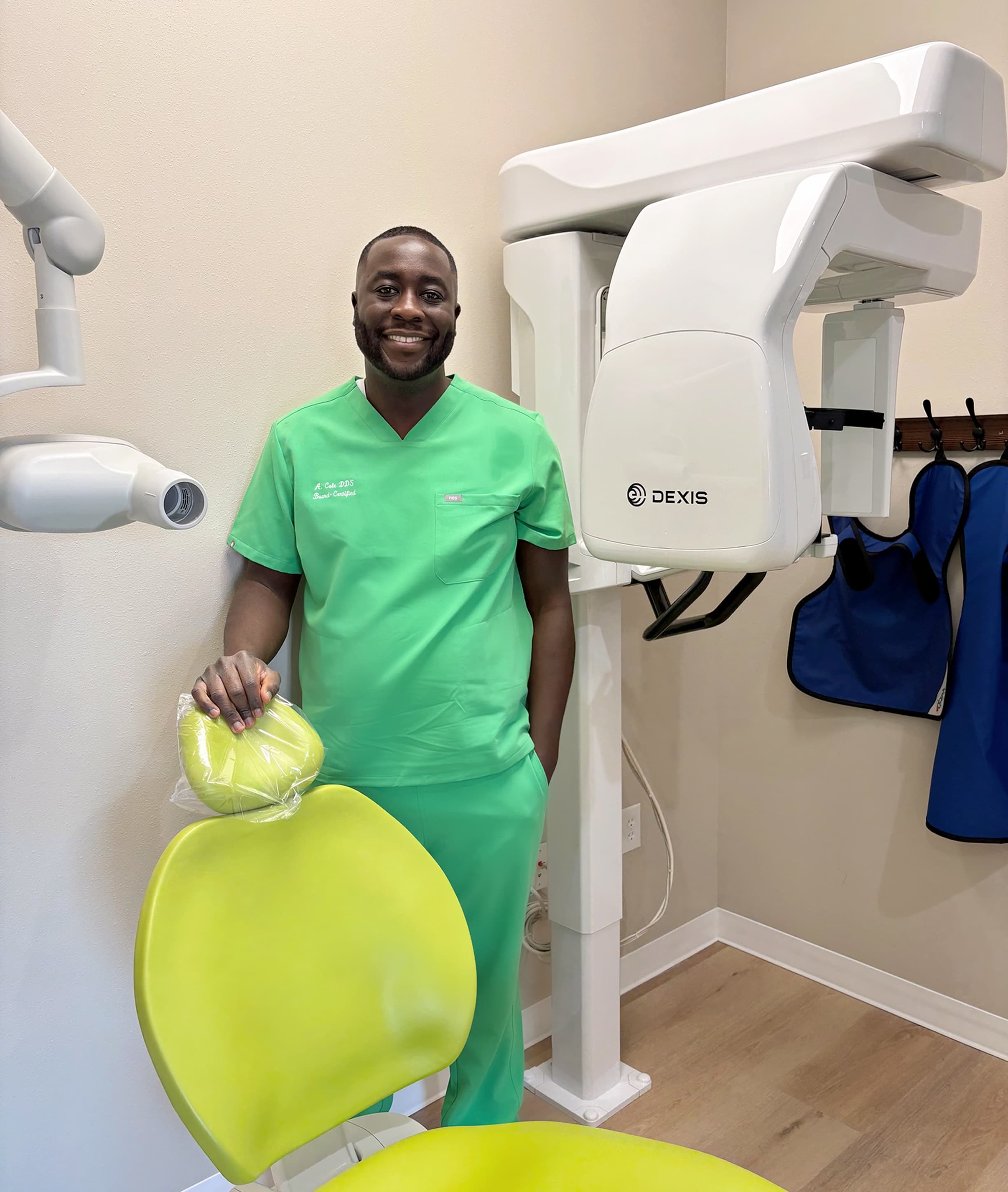 Dr. Ademola Cole standing in a pediatric dental treatment room